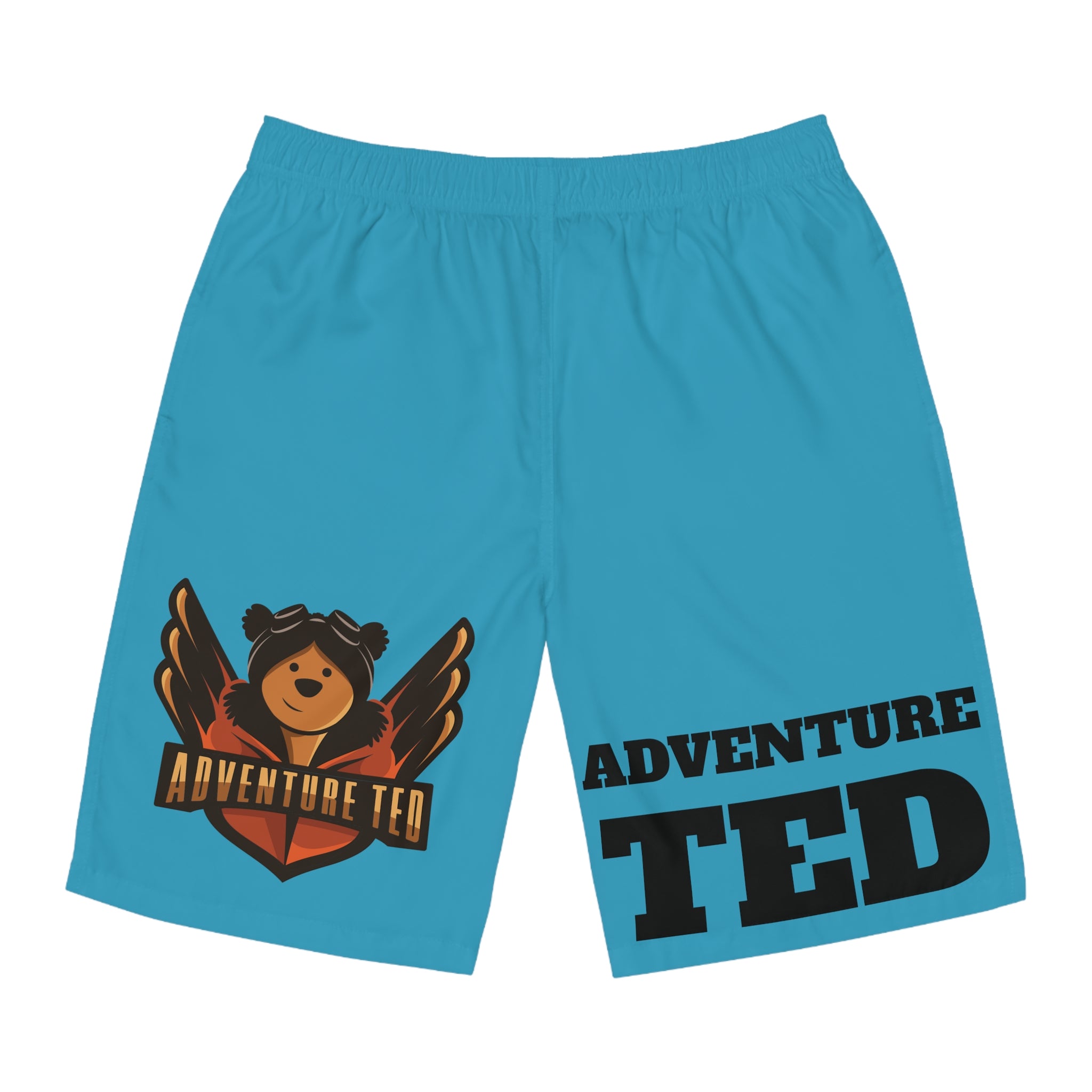 A pair of blue board shorts with a graphic of a bear wearing a helmet and the text 'ADVENTURE TED' on the right leg.