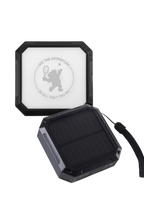 Black solar panel with a white label featuring a logo and text on a white background