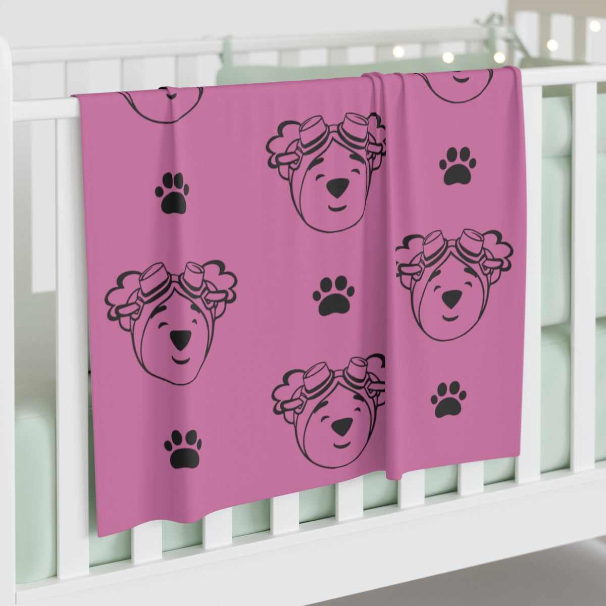 Jersey polyester blanket with paw prints and adventure ted outline. 30 inches by 40 inches (76.2cm × 101.6cm)